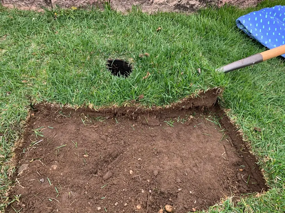 Landscaper prying up sod