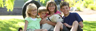 dog and children in yard