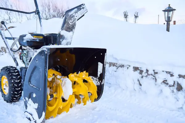 Snow blower on a driveway.