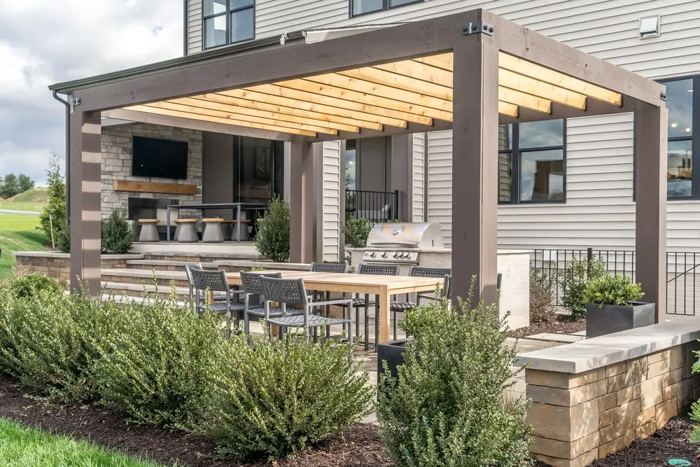 Seating area on backyard patio under a pergola