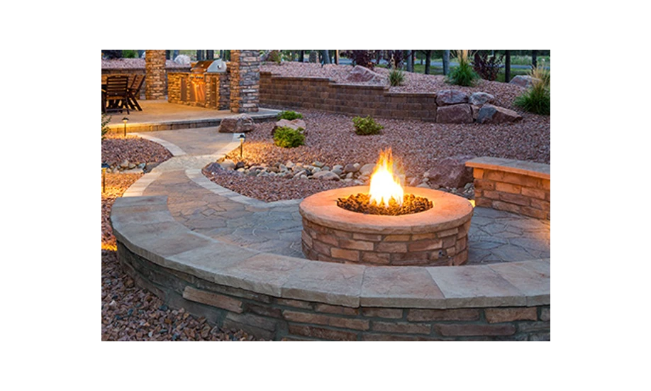 lit stonework fire pit with built-in wrap-around bench.